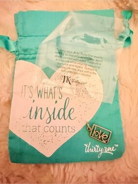 thirty-one silver 'love' charm